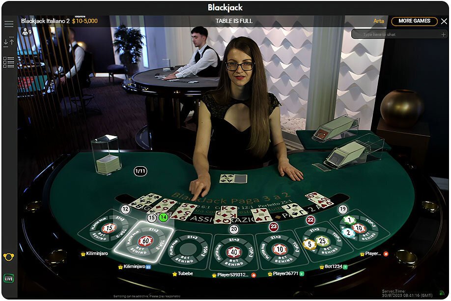 A screenshot with a live casino dealer managing a blackjack table